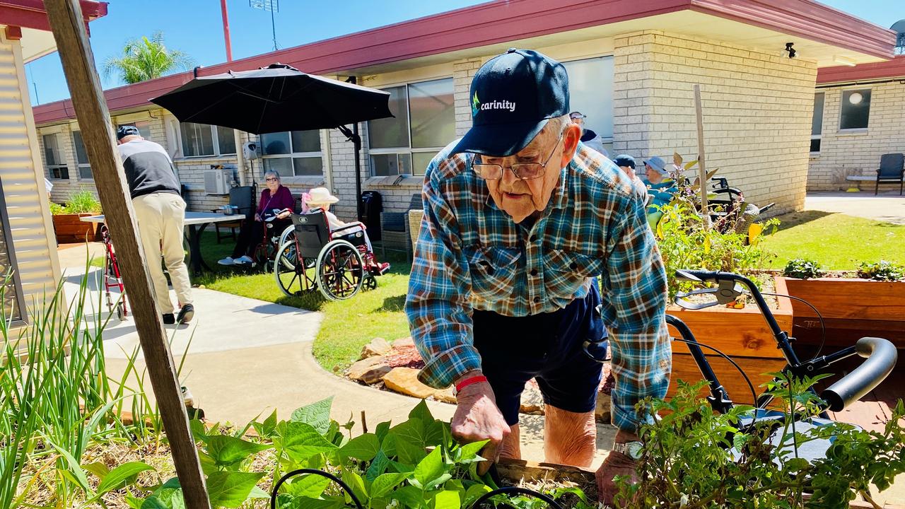 Carinity Karinya Place resident Colin Hughes enjoys gardening at the aged care community in Laidley. Photo: Supplied