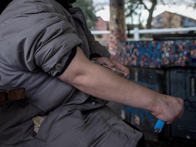 A man uses a needle at the North Richmond commission flats on Thursday. Picture: Jake Nowakowski