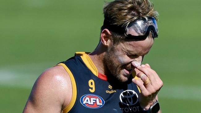 ADELAIDE, AUSTRALIA - MARCH 08: Rory Sloane of the Crows wipes the sweat out his eyes from wearing ski goggles  during an Adelaide Crows AFL training session at West Lakes on March 08, 2024 in Adelaide, Australia. (Photo by Mark Brake/Getty Images)