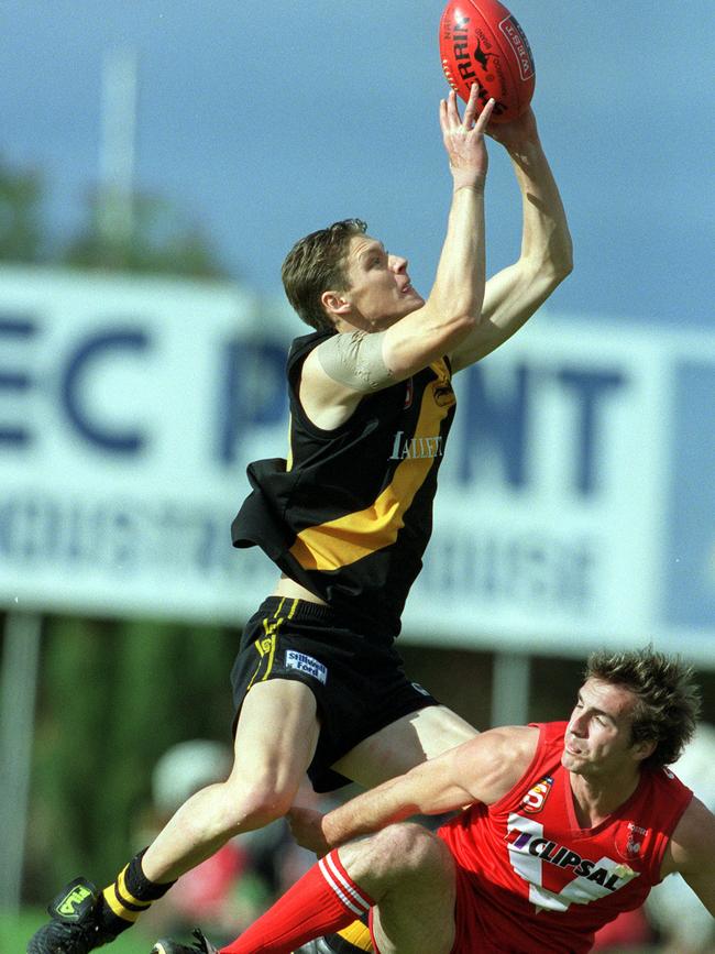 Laurence Angwin taking a mark against North Adelaide for Glenelg in 2001.