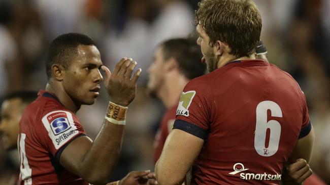 Filipo Daugunu and Angus Scott-Young celebrate the Reds’ win.