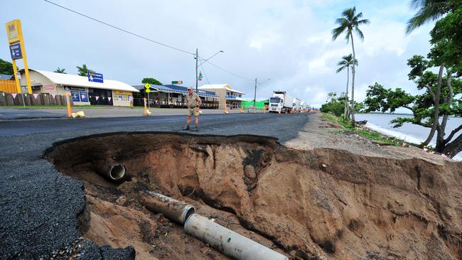 Heavy rain and flooding causes major issues in north Queensland, like this section of the Bruce Highway at Cardwell between Townsville and Cairns.