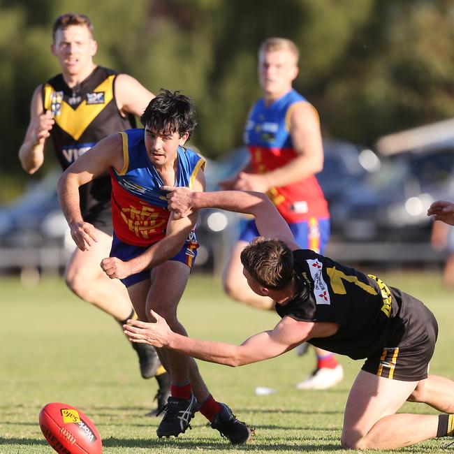 Mulwala’s Zach Scott leads the race for the ball against Cobram. Picture Yuri Kouzmin