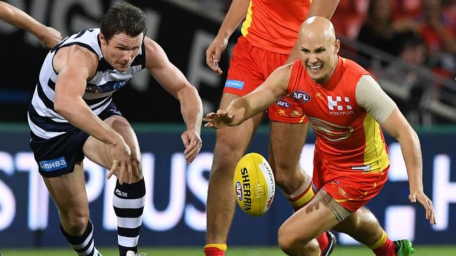 Patrick Dangerfield and Gary Ablett battle for the ball.