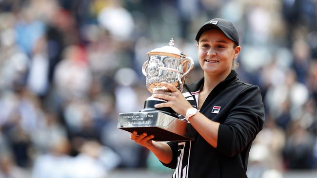 Ash Barty celebrates with the trophy after winning the French Open.