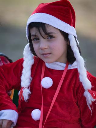 Peace and goodwill ... An Iraqi Christian child dressed in a Santa costume in Erbil, Iraq, a refuge for an estimated 250,000 Syrian refugees. Source: Getty