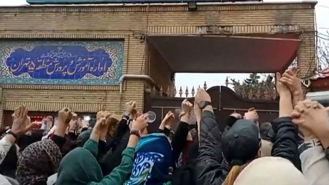 Families chant slogans outside an education ministry building in Tehran last month, following poisoning attacks on students. Picture: AFP