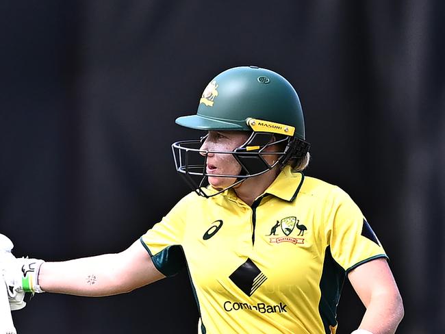 SYDNEY, AUSTRALIA - JANUARY 12: Alyssa Healy of Australia raises her bat to celebrate completing her half-century during game one of the Women's Ashes ODI series between Australia and England at North Sydney Oval on January 12, 2025 in Sydney, Australia. (Photo by Ayush Kumar/Getty Images)