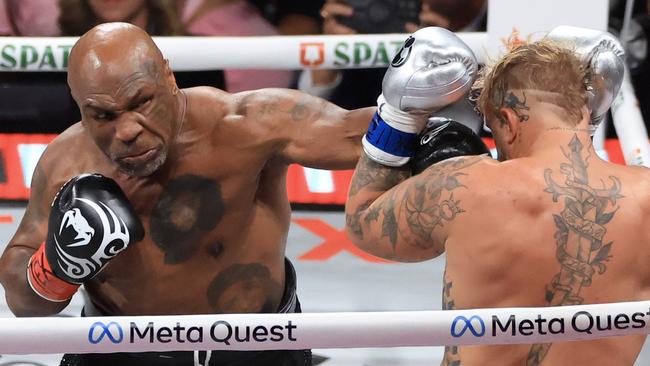 ARLINGTON, TEXAS - NOVEMBER 15: Mike Tyson (L) punches Jake Paul during their heavyweight bout at AT&T Stadium on November 15, 2024 in Arlington, Texas. (Photo by Christian Petersen/Getty Images)