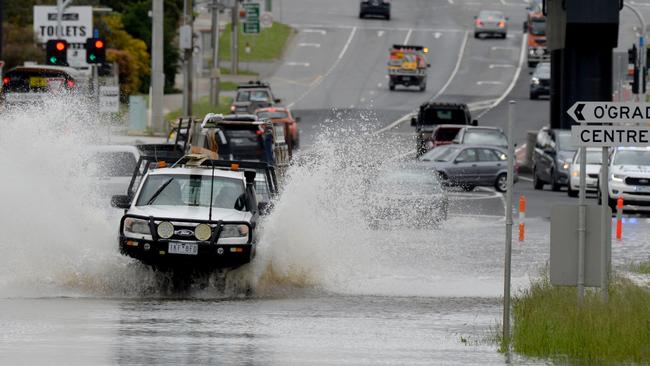 Floodwaters partially block Hallamn Rd South at Hallam. Picture: Andrew Henshaw