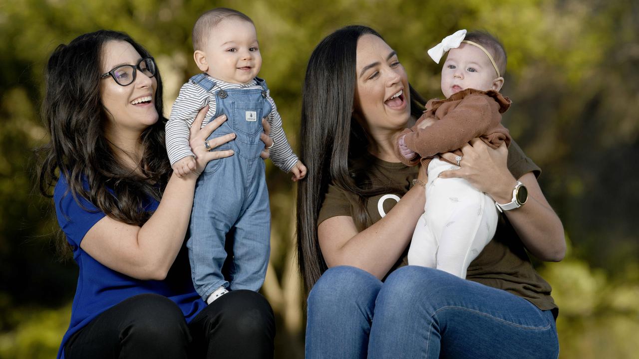 Oliver, 7 months (with mum Celeste, left) and Charlotte, 5 months (wearing a bow, with mum Georgia, third from left). Picture: NCA NewsWire/Naomi Jellicoe