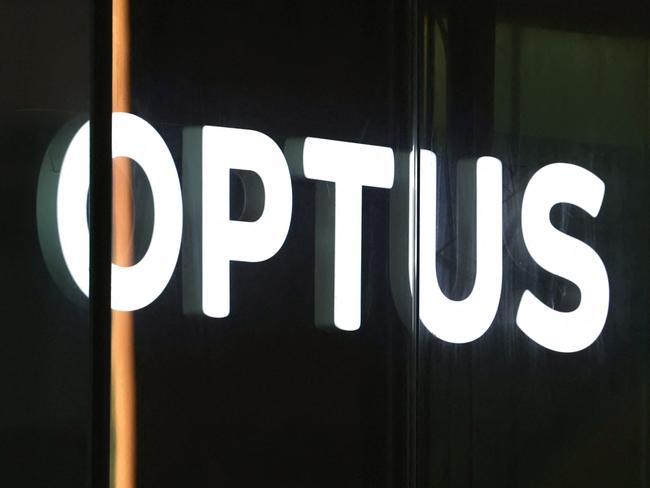 An illuminated sign is displayed in the window of an outlet for the Australian communications company Optus in Sydney on November 9, 2023. Australia's government on November 9 launched an investigation into a nationwide communications outage that crippled phone lines and severed internet access for 10 million customers countrywide. (Photo by DAVID GRAY / AFP)