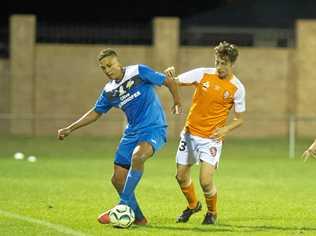 IN CONTROL: Thunder striker Travis Cooper (left) holds off Brisbane Roar player Kai Trewin during their match last week. Picture: Nev Madsen