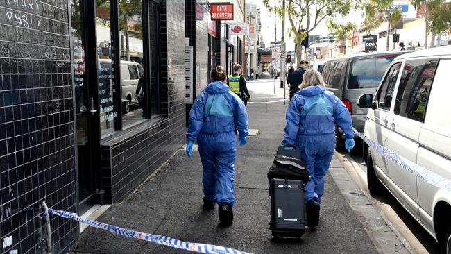 Forensic police on the scene in Footscray where a woman was found stabbed to death. Picture: Andrew Henshaw