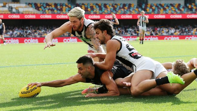 Michael Gibbons of the Blues dives for the loose ball under Josh Daicos and Jack Crisp of the Magpies. Picture: Michael Klein