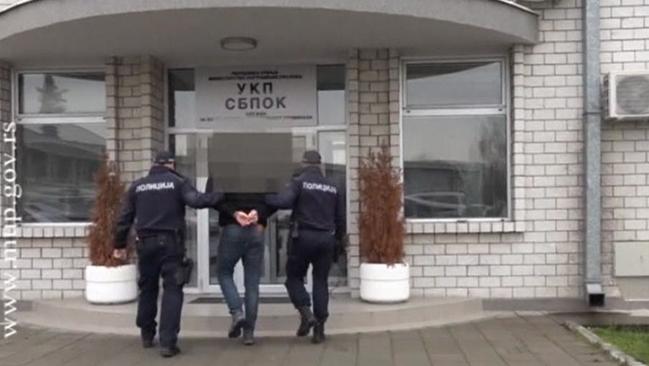 Serbian police take one of the men into custody. Picture: Serbian Interior Ministry