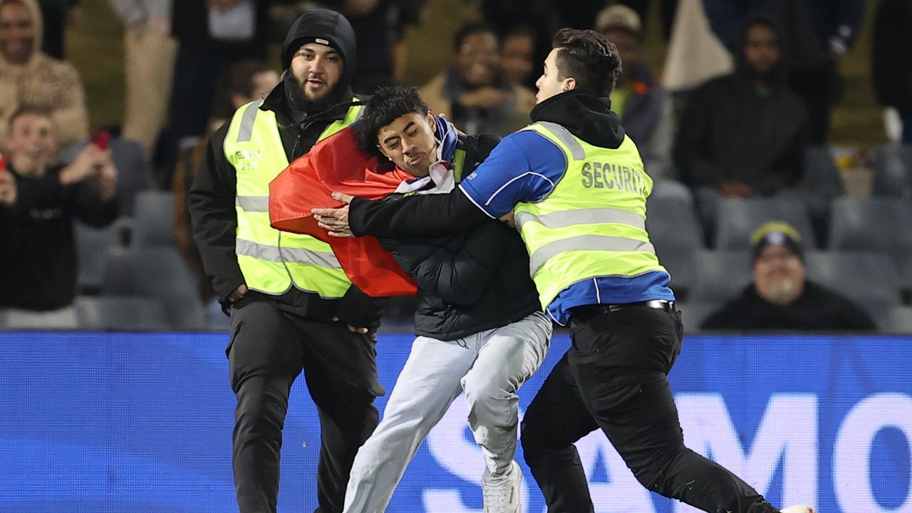 Another intruder tried his luck at the game between Samoa and Cook Islands. (Photo by Mark Kolbe/Getty Images)