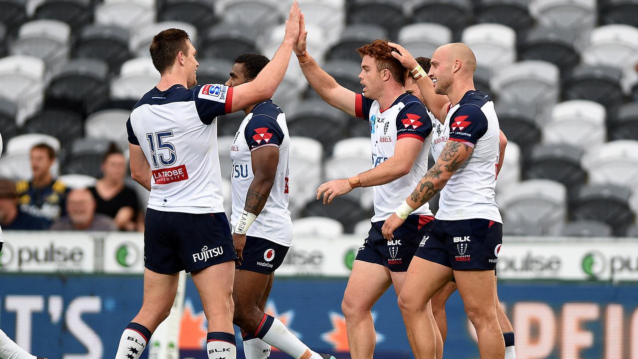 The Rebels celebrate a try scored by Andrew Kellaway at Forsyth Barr Stadium.