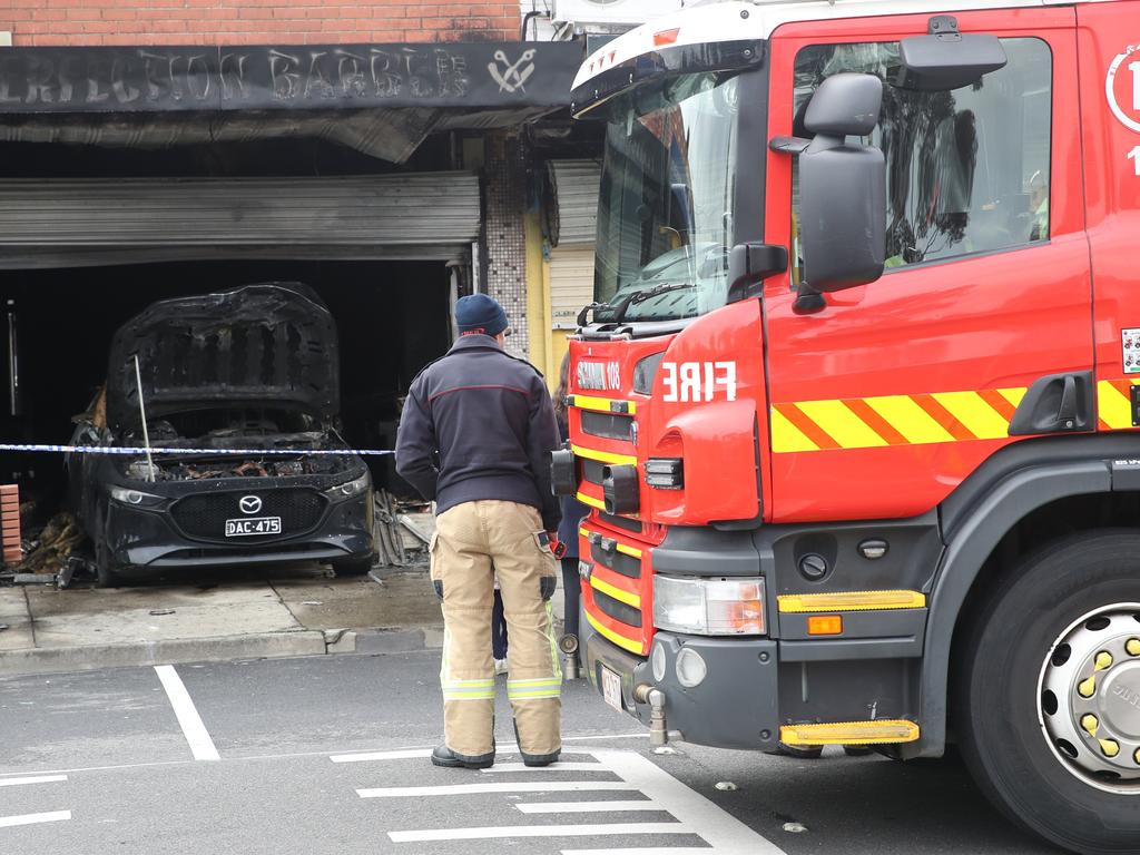 A car ploughed into a Lalor barber shop and was set alight early Tuesday morning. Picture: David Crosling