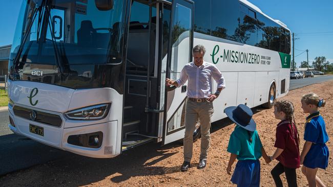 Michael Baulch, director of Emerald Coaches, with local schoolchildren boarding an Emerald Coaches bus.