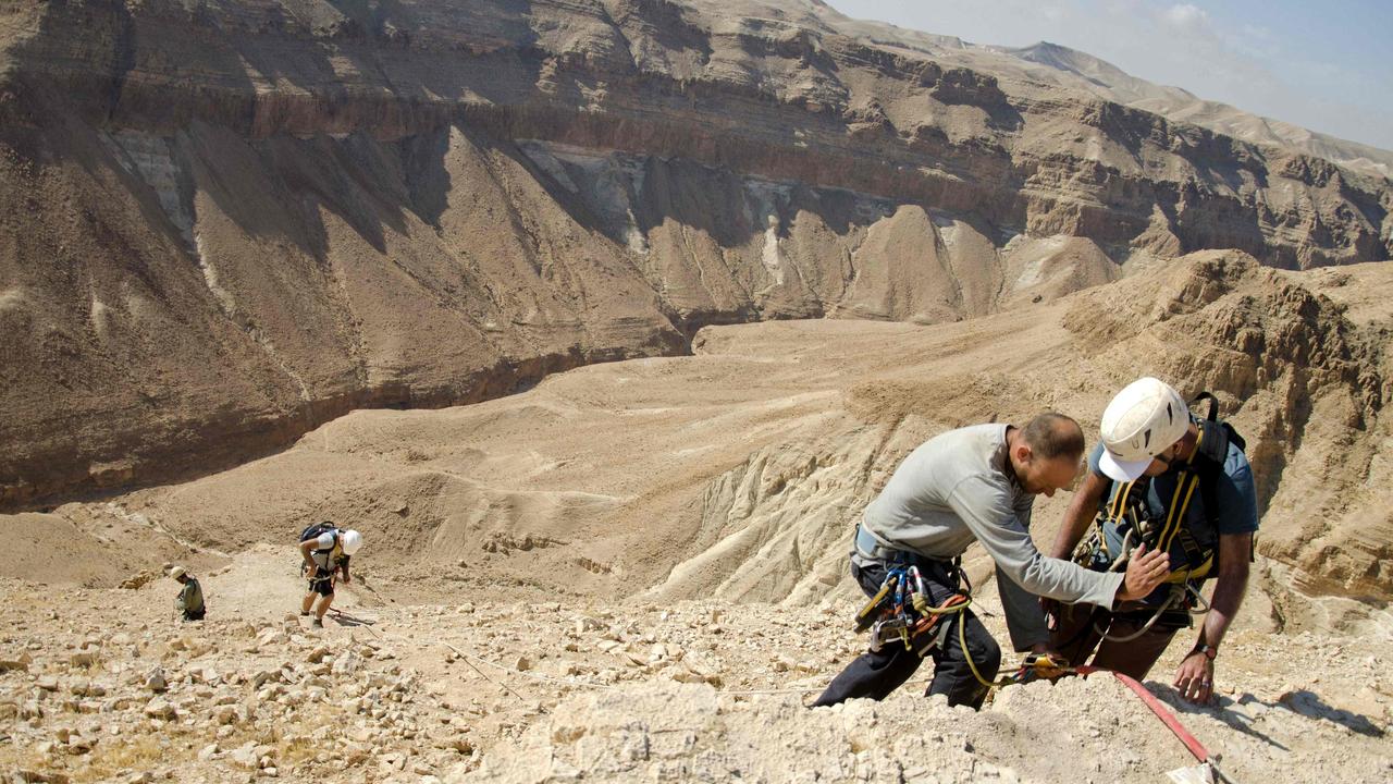 Archaeologists had to use abseiling equipment to access the cave for the excavation. Picture: Yoli Schwartz/Israeli Antiquities Authority/AFP