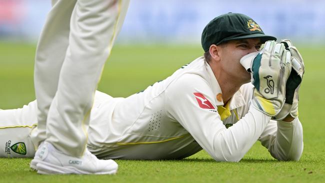 Alex Carey reacts after dropping Harry Brook when he was on five. It was one of five dropped catches by Australia on day one. (Photo by Stu Forster/Getty Images)