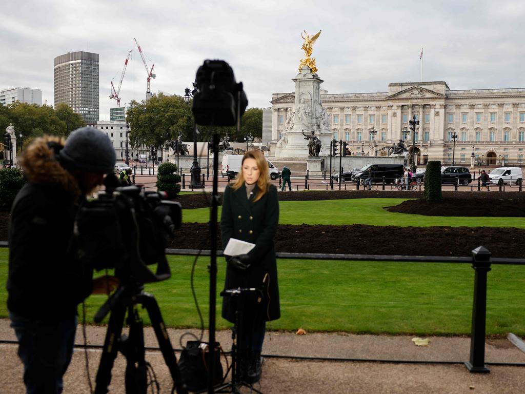 A news crew reports from outside the Buckingham Palace last week after revelations the Queen spent the night in hospital. Picture: AFP