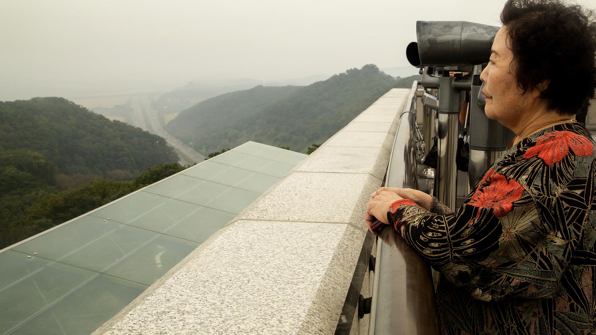 Im Geum-Ja (73), who was born in North Korea before the 1950-53 Korean War and is living in the South, looks north at Mt. Ohdu Unification Observatory in the demilitarized zone (DMZ), about 2 km (1.2 miles) south of North Korean county of Kaepung, in Paju, 35 km (22 miles) northwest of Seoul, South Korea on Oct 1, 2017, before the Chuseok (Korean Thanksgiving Day) holiday. (Photo by Lee Jae-Won/News Corp Australia Network)