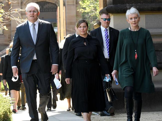 Prime Minister Scott Morrison (left) and wife Jenny Morrison (centre) are seen arriving at the funeral for the former NSW Premier. Picture: NCA NewsWire/Bianca De Marchi