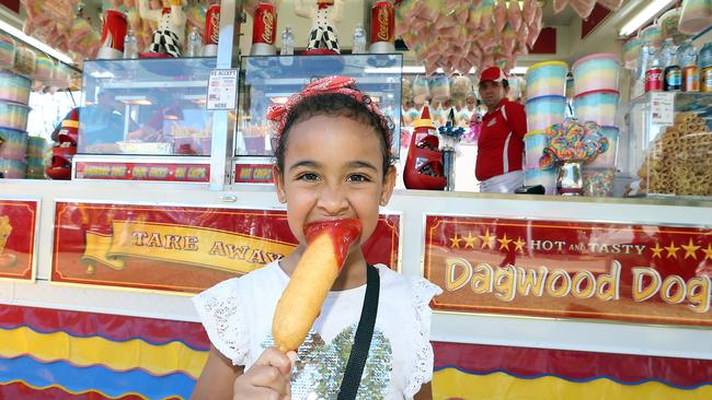 Sovaia Nullmeyer enjoying her first ever dagwood dog at the Gold Coast Show. Picture: Richard Gosling