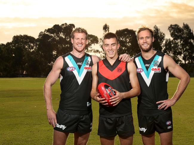 Rostrevor old scholars Tom Jonas (left) and Jack Hombsch (right) with the college’s 2018 captain, AFL draft hopeful Luke Valente. Picture: Dylan Coker.