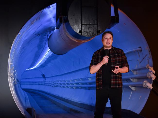 Elon Musk, co-founder and chief executive officer of Tesla Inc., speaks during an unveiling event for the Boring Company Hawthorne test tunnel in Hawthorne, south of Los Angeles, California on December 18, 2018. - Musk explained that the snail moves 14 times faster than a tunnel-digging machine.  On Tuesday night December 18, 2018, Boring Co. officially opened the Hawthorne tunnel, a preview of Elon Musk's larger vision to ease L.A. traffic. (Photo by Robyn Beck / POOL / AFP)