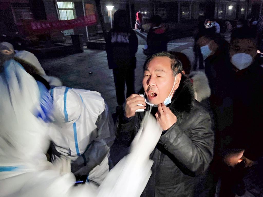 Residents queue to undergo nucleic acid tests for the Covid-19 coronavirus in Huaxian county, Anyang city, in China's central Henan province. Picture: AFP