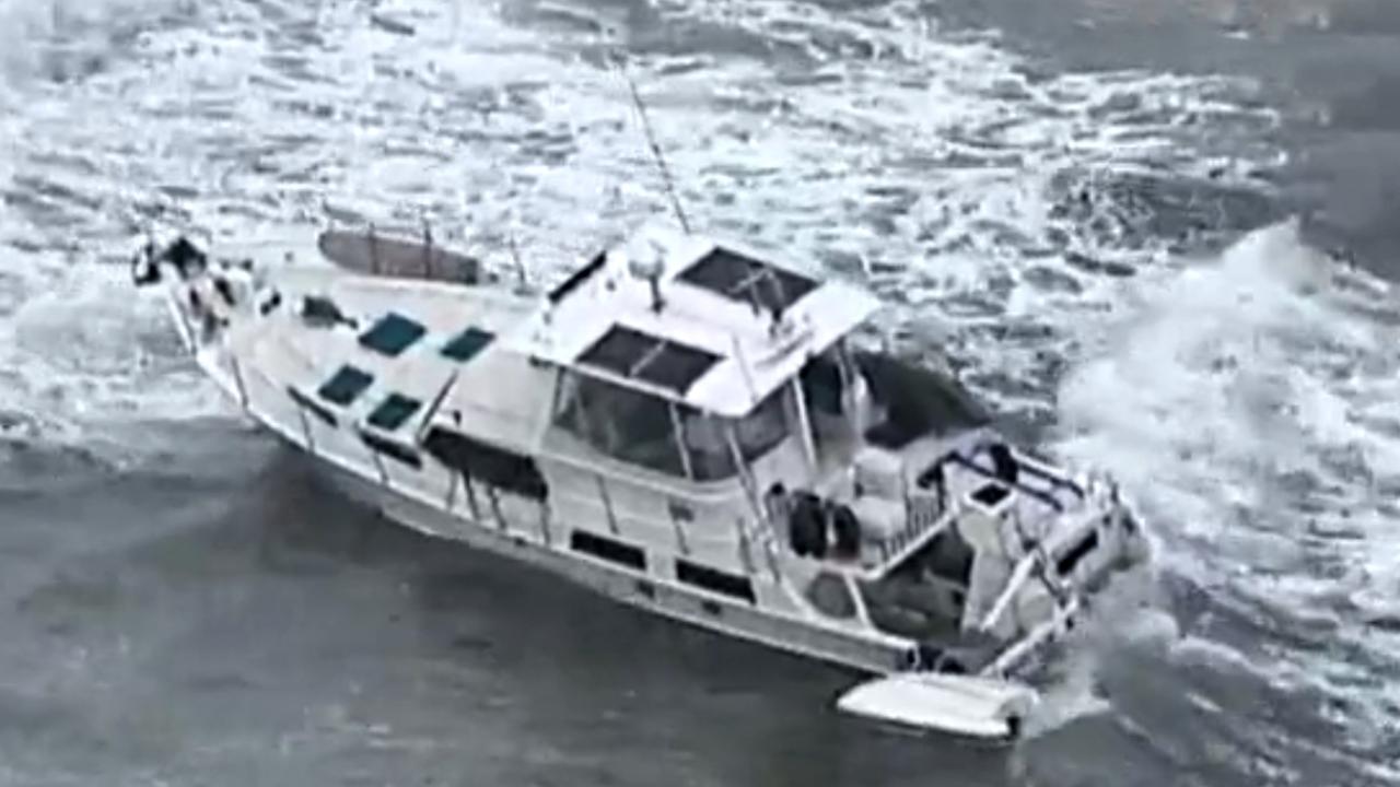 A police officer and lifesaver take control of the vessel. Picture: 7 News