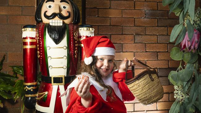 Isabella Botten is excited to show off the Christmas lights display her family has made at their Kearneys Spring home, Tuesday, November 30, 2021. Picture: Kevin Farmer