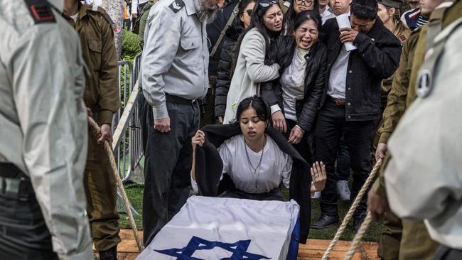 Family members of Israeli-Filipino soldier Cedric Green (Cidryk Garin), one of 21 soldiers killed in a single incident while in combat in the Gaza Strip on January 23, gather around his casket during his funeral at the Kiryat Shaul cemetery in Tel Aviv on January 25, 2024. Picture: Marco Longari/AFP