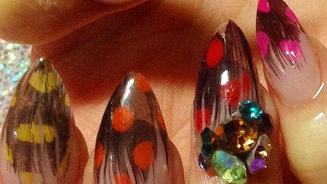 Elise took five hours to intricately encapsulate fine feathers on acrylic nails before using polish and Swarovski crystals to complete the look