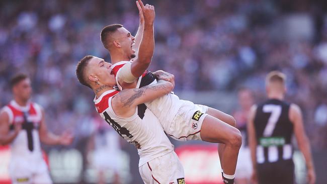 Matty Parker and Robbie Young celebrate a Young goal against the Magpies.