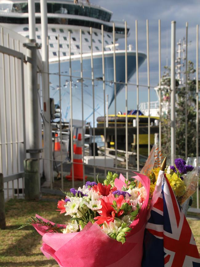 Flowers left behind at the port in Tauranga, with the Ovation of the Seas in the background. Picture: Charles Miranda