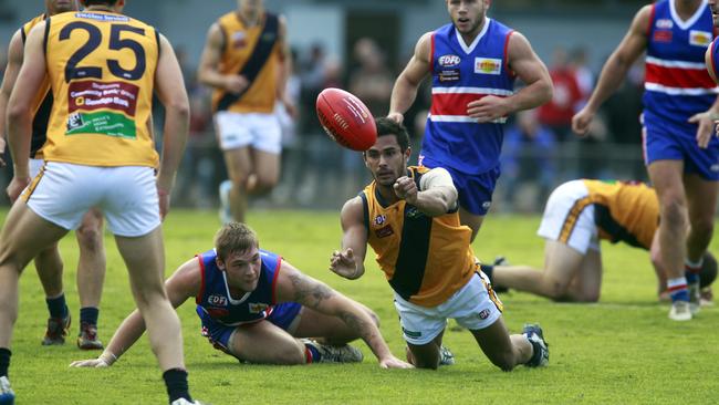 Strathmore’s Matthew Knight fires out a handball against Keilor earlier this season. Photo: Richard Serong