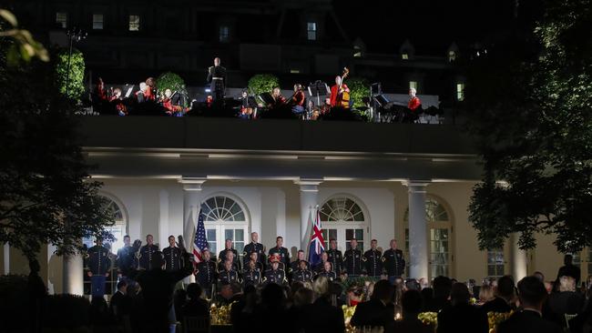 Guests listen to music in the Rose Garden of the White House.