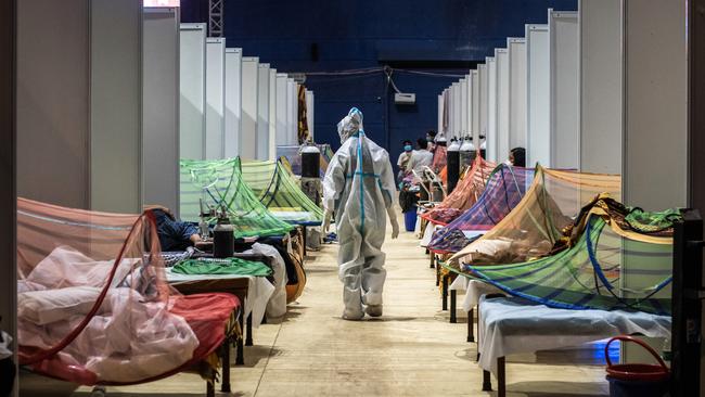 A medical worker in a makeshift COVID-19 care facility in a sports stadium at the Commonwealth Games Village in New Delhi. Picture: Getty Images