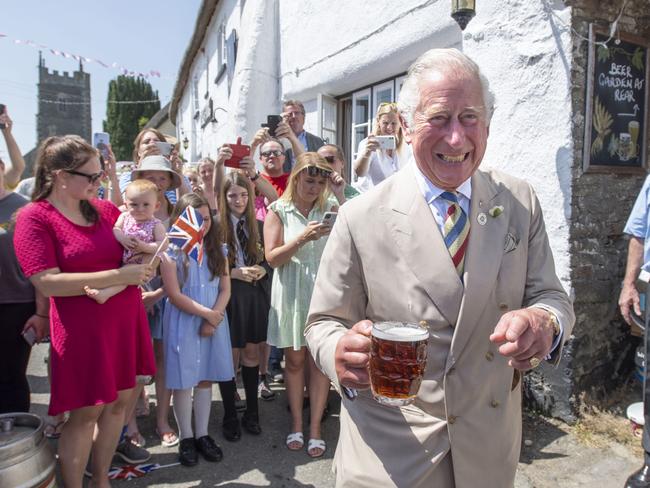 Prince Charles drinks a pint of Bayes Topsail during a visit to the Duke of York Public House in Devon. Picture: David Rose - WPA Pool/Getty Images.