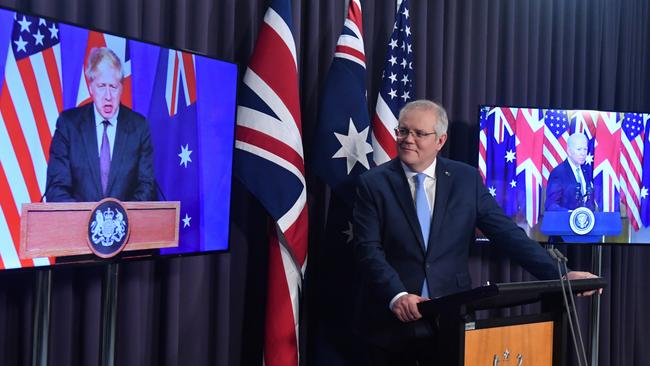 Scott Morrison speaks to Boris Johnson, left, and Joe Biden from Parliament House in Canberra on Thursday. Picture: AAP