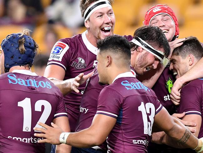 BRISBANE, AUSTRALIA - FEBRUARY 22: James O'Connor of the Reds celebrates with team mates after scoring a try during the round four Super Rugby match between the Reds and the Sunwolves at Suncorp Stadium on February 22, 2020 in Brisbane, Australia. (Photo by Bradley Kanaris/Getty Images)