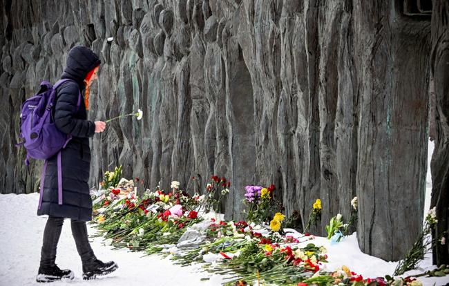 Some mourners gathered at a monument to victims of Soviet-era repression known as the 'Wall of Grief'