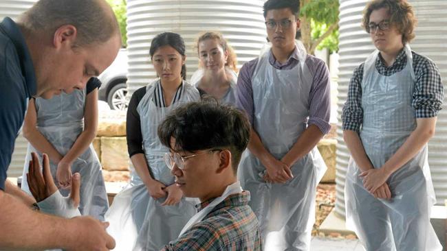 Jacqui Chin, Sophie Olufson, Makesh Gounden and Thomas Thurecht watch 'patient' Thomas Wong get a cast on. Picture: Jann Houley