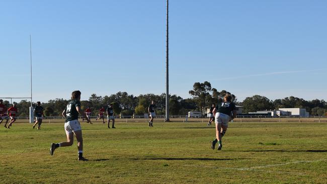 Spectators cheer on as they watch the B Grade St George vs Condamine match at the Roma Rugby Races at Bassett Park. Picture: Chloe Cufflin.