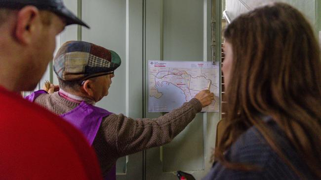 An AEC staff member locates a voters voting area on a map at a polling centre in Melbourne, Australia. Picture: Asanka Ratnayake/Getty Images