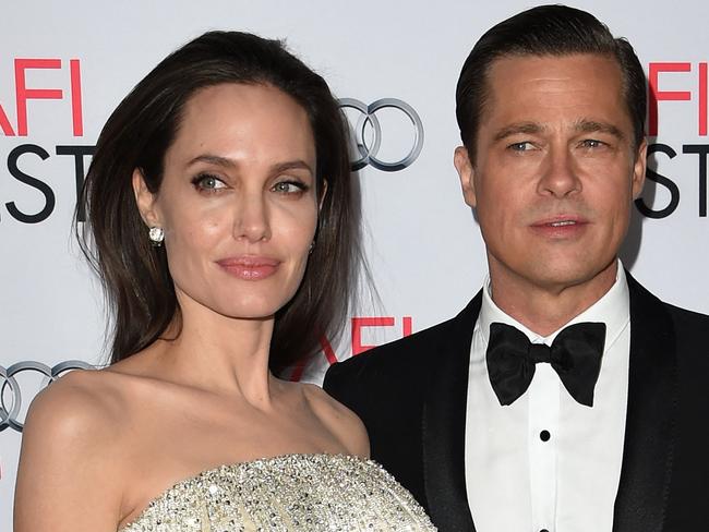 (FILES) Writer-director-producer-actress Angelina Jolie Pitt (L) and actor-producer Brad Pitt arrive for the opening night gala premiere of Universal Pictures' "By the Sea" during AFI FEST 2015 presented by Audi at the TCL Chinese Theatre in Hollywood, California, on November 5, 2015. Famed actors Brad Pitt and Angelina Jolie signed off on a divorce settlement on December 30, 2024, according to People Magazine, marking a turning point in the eight-year legal saga. (Photo by MARK RALSTON / AFP)